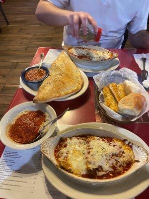 Full dinner with eggplant parm, calzone, free bread, and pasta trio