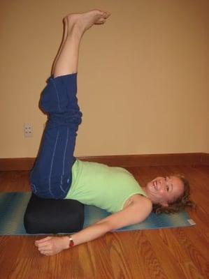 Legs up the wall using bolster--similar benefits to shoulder stand without the risks of shoulder stand