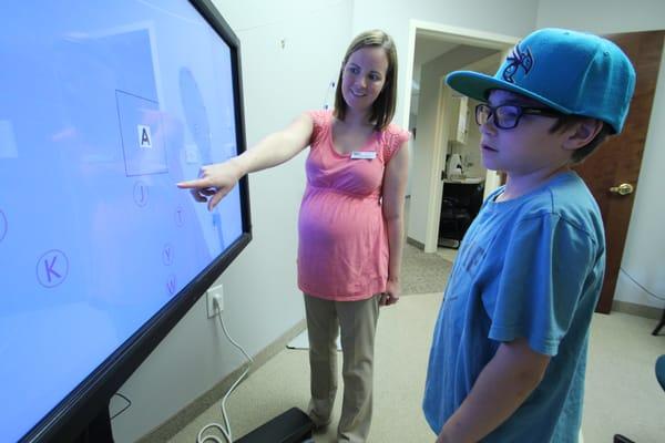 Dr. Gesford training a young gentleman in vision therapy.