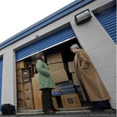 Marnie Dawson looks over a storage locker with Client. Image from REUTERS/Jim Young