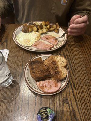 Ham and over medium eggs with country potatoes with no onions or bell peppers and wheat toast and coffee.