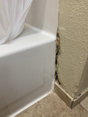 Bathroom wall full of holes.