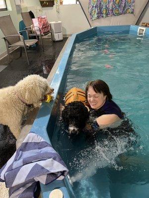 Sister Mataya encourages her brother in swim class with Kathy Carr