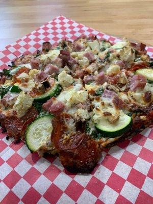 Fresh made pizza at Rollingstone Pizza inside New Earth Market