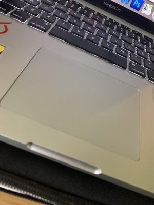 Touch pad was previously protruding out and is now flush with the laptop after repair.