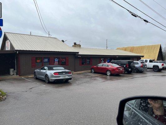 Exterior (front) - large parking lot.  Bar is the left side of the building; cafe is on the right.