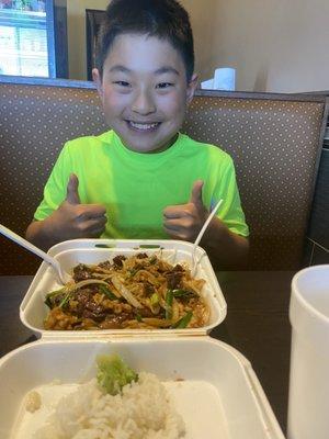 Happy boy with a mass of Mongolian beef and chicken. He left nothing behind.