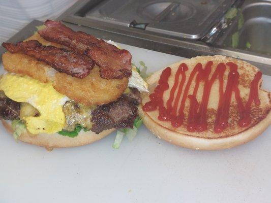 The Brunch Burger beef Patty, Lettuce,Tillamook Cheese, Bacon, Hash brown, egg, Mayonnaise, and ketchup  delicious.