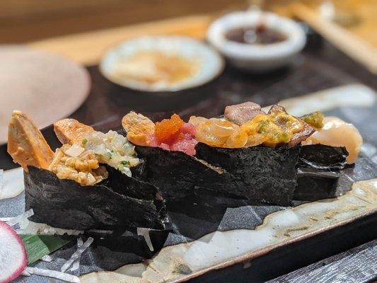 One of the Omakase courses with Monkfish liver, squid, clam, tuna and uni/beef.