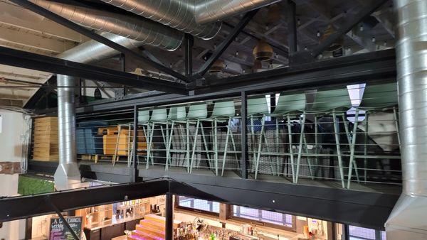 Indoor balcony seating that overlooks the party below