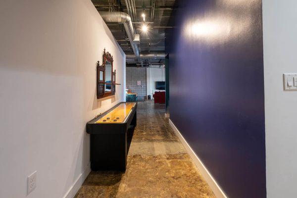 Disco Suite | Hallway | Our space is complete with a shuffle board game table.