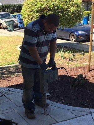 Juan removing a few square feet of concrete to access sewage line