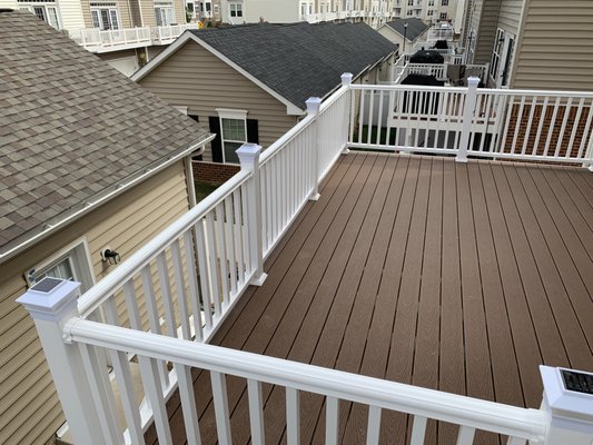 Composite decking and railings with Azek trims and post sleeves. Trex Select with hidden fasteners. Frederick, MD