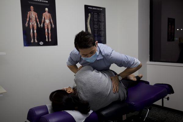 Dr Leo doing chiropractic adjustment. Really helps with back pain related to frequent computer work.