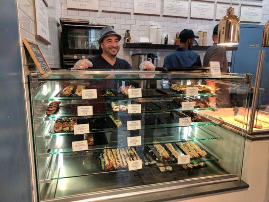 Counter of sandwiches and the Sandwich Chef saying hi!