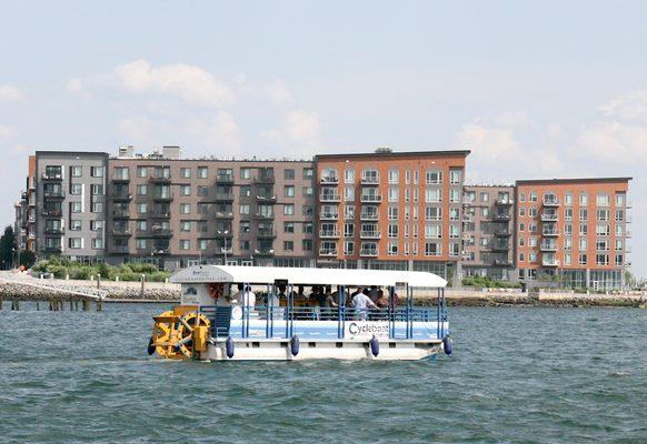 Rosie the Riveter Cycleboat cruises past the East Boston waterfront.