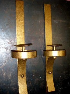 Set of sconces with two-toned gold metallic finish.