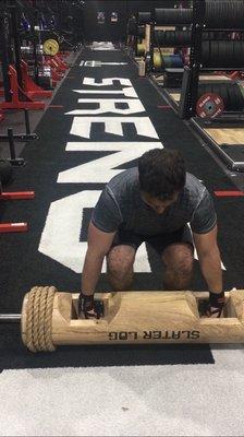 One of the logs. Staring down the carpet that can be used for carries and sleds, all the way to the other side of the gym.