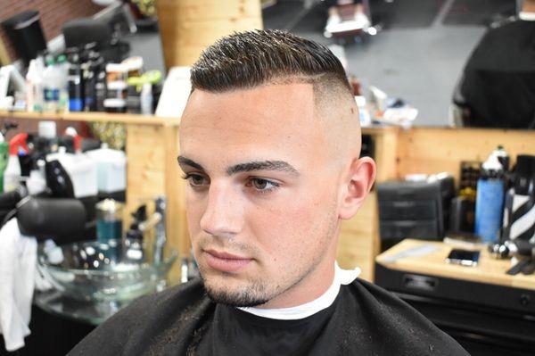 Skin Fade Haircut with a Hard Part... Book your appointment booking.blastbarberstudio.com