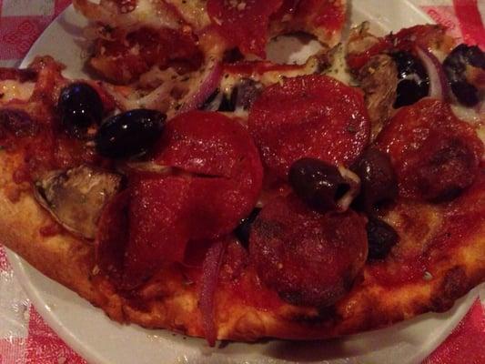 Pizza with pepperoni, fresh mushrooms, red onion, kalamata olives, sun dried tomatoes and oregano. Yum!