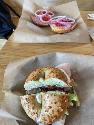 Build your own-pesto Parmesan bagel,turkey, avocado, bacon, pesto cream cheese and tomato. Salami sammo in the back