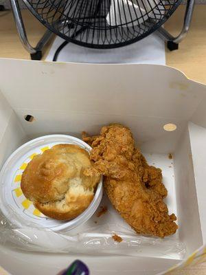 Chicken tenders with biscuit and side.