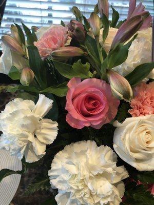 5 white roses and 3 pink roses total with carnations and the closed buds you see here. (Premium Arrangement)