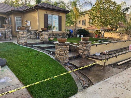 Concrete stairs/steps, columns with veneer, and retaining block wall