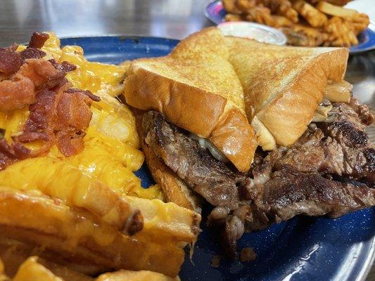 Steak sandwich with Texas toast bread, with grilled mushrooms and onions -- with loaded fries