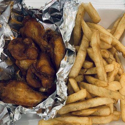 Hot Buffalo wings with seasoned fries