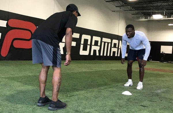 Coach Flight working with Dallas Cowboys, Xavier Woods.