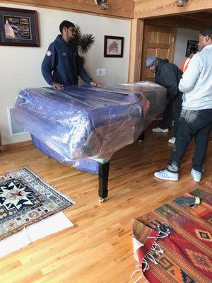 Wrapping and preparing a concert grand piano for transport