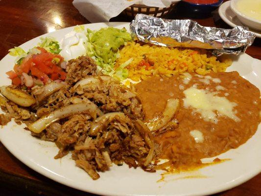 Carnitas (Pork served with rice and beans, sour cream, pico de gallo, and tortillas)