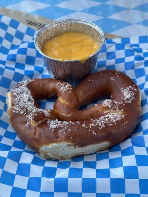 Small pretzel with cheese dip sauce