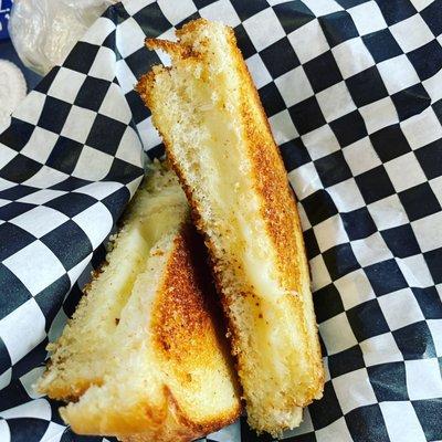 All American grilled cheese American cheese served on Texas toast with a side of ruffles potato chips