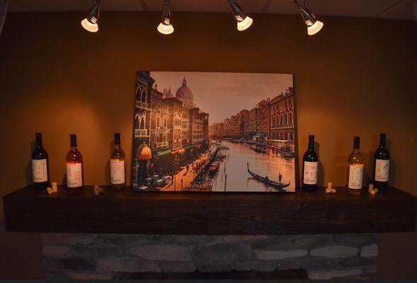 Fireplace Mantle: 6 La Famiglia wines  Left to right (Journeyman's Craft, Open House, Finishing Touch, Rough-in, Punch List, Blueprint)