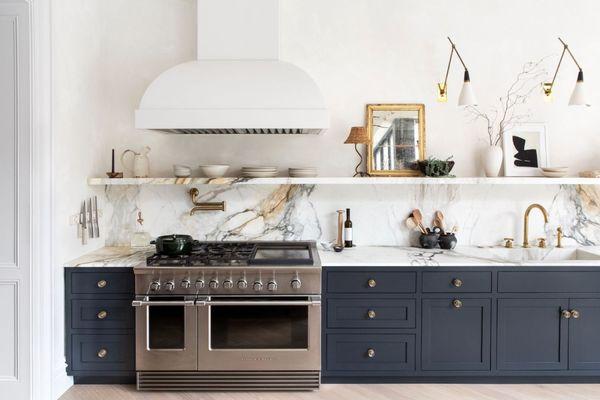 Featuring a stunning custom kitchen project with sleek dark cabinets and luxurious marble countertops & backsplash.