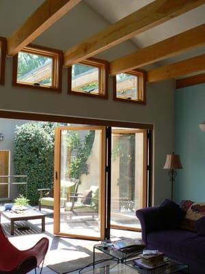 The room opens to the adjacent outdoor room doubling the size of the family room simply by opening the doors