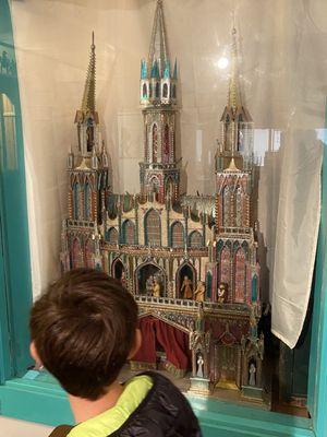 Puppet set of nativity in a cathedral made of candy wrappers.