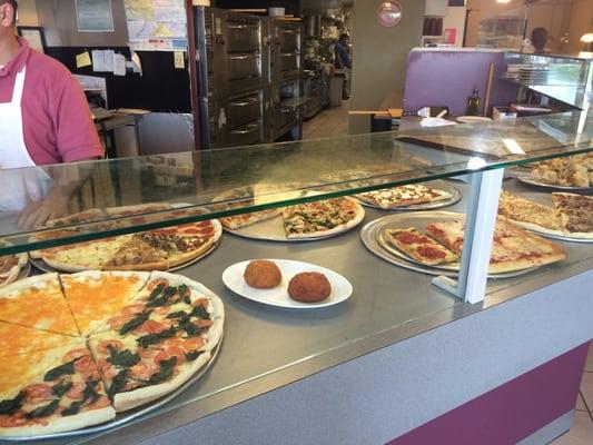 Great array of many varieties of pizzas and garlic knots