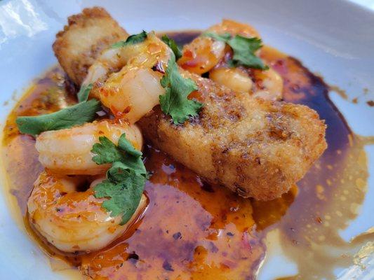 Thai chili shrimp, sour spicy glaze, crispy rice, cilantro, sesame seeds, and sweet soy sauce.