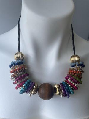 Multi colored beaded circles with wood bead on leather cord.