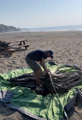 Setting up our tent on the beach