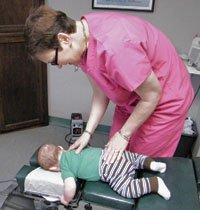 Dr. Beth Blakely at work with an infant | Carmichael Chiropractor