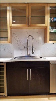 The solid backsplashes are so easy to clean! No grout that needs constant attention and cleaning!