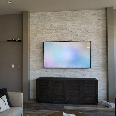 TV mounted on brick wall