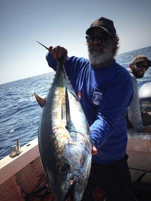 Yellowfin tuna held up for a photo after a 25 fish stop