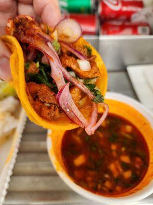 Close-up shot of the birria taco and consomme