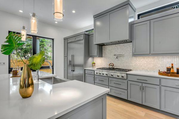 If you're looking for a fresh kitchen update, consider grey cabinets! They're unexpected and chic.