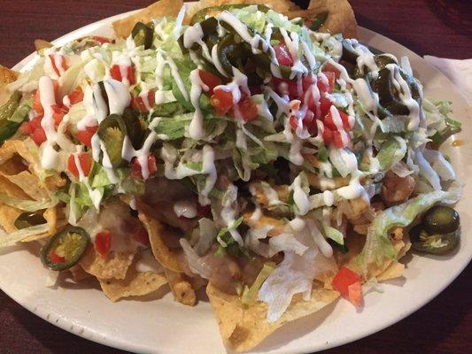 Heaping plate of fajita chicken nachos.